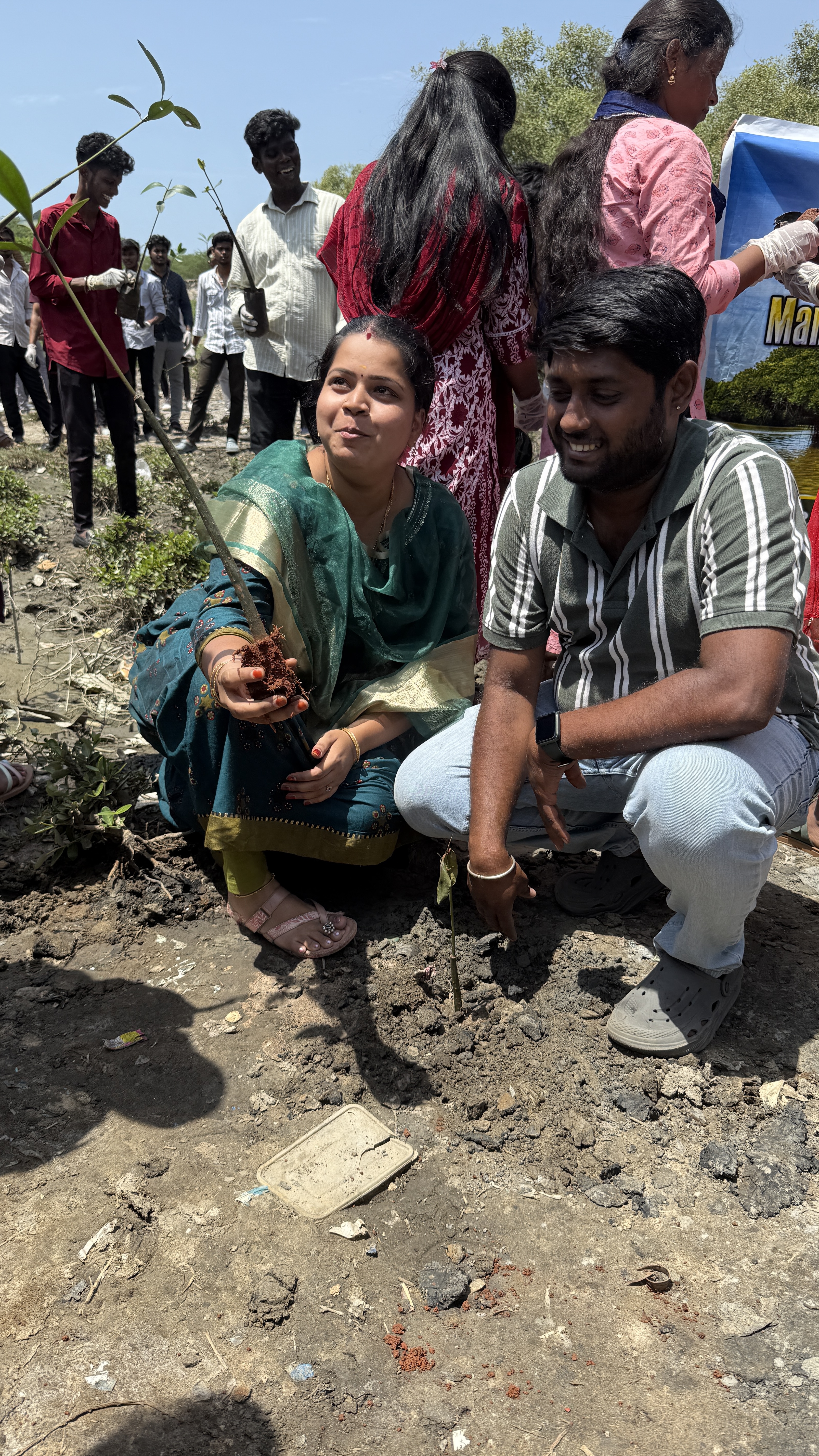 Couple planting a sapling