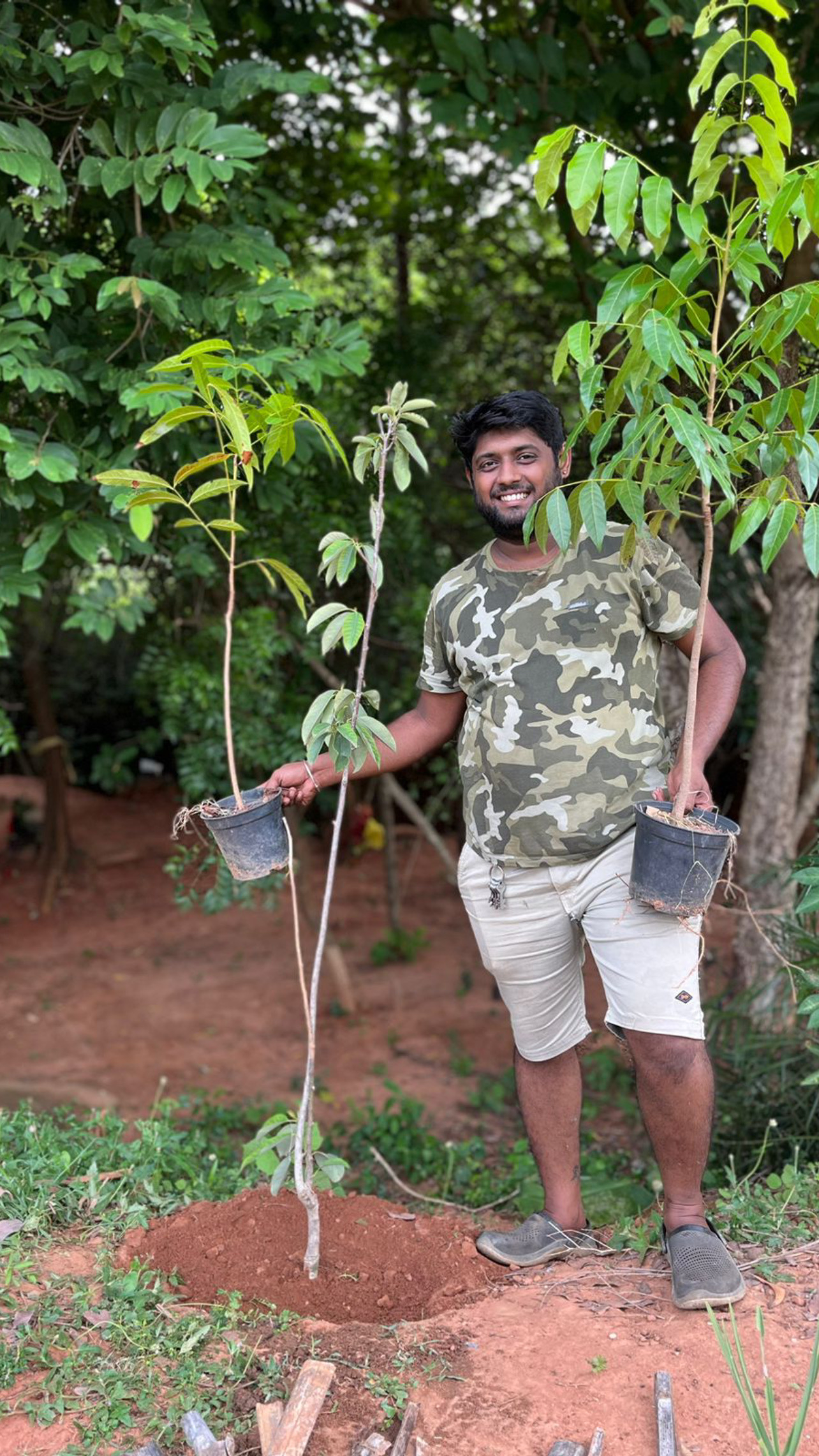 Volunteer holding saplings